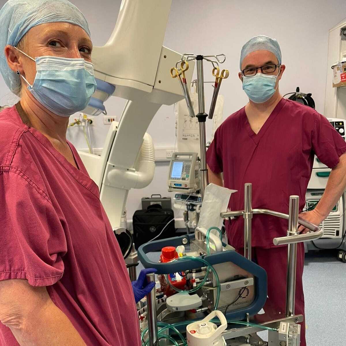 Header_Ecmo a couple of people wearing scrubs and masks